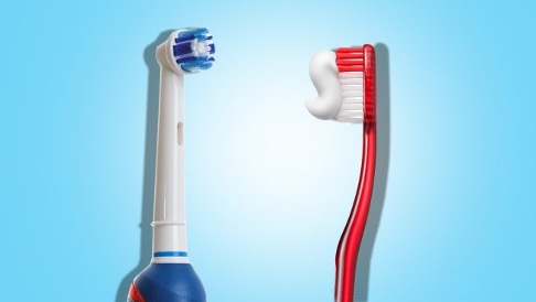 A blue and white electric toothbrush on the left with a red toothbrush on the right